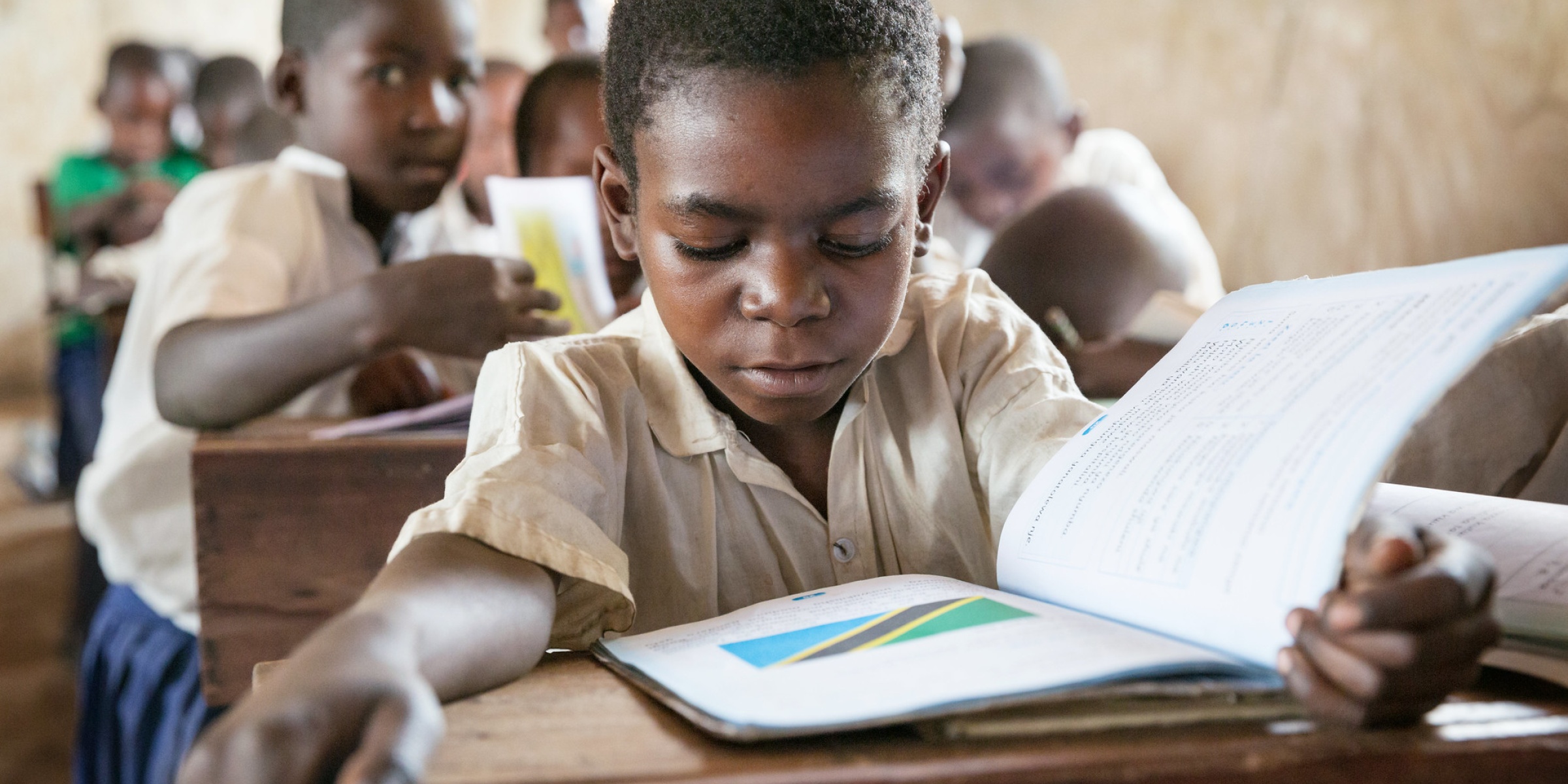 Student with textbook, Kasakola Primary School, Mpanda, Katavi, Tanzania. Credit: GPE/Kelley Lynch